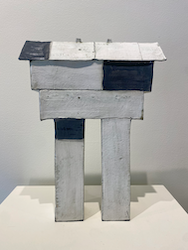 Tall house structure on two legs with black roof detail